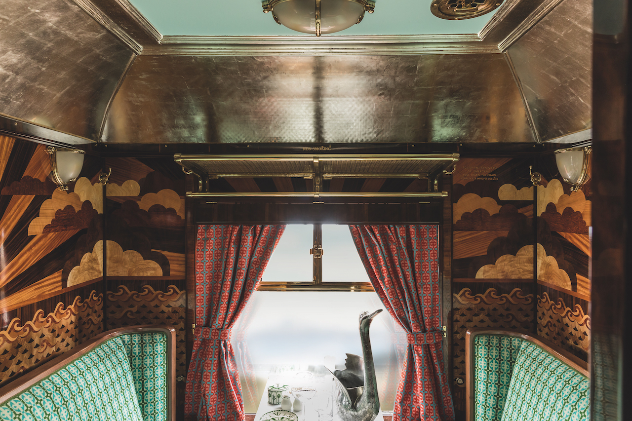 The iconic British Pullman, A Belmond Train, has given its  Cygnus carriage a stunning new look in an exciting collaboration with filmmaker Wes Anderson.